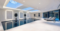 Beautiful large indoor pool with dark liner and light surrounding slabs