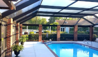 Pool enclosure with brick clad piers and heavy timber roof