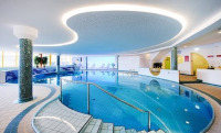 Large indoor freeform pool with reflected shape effect in LED lights on ceiling