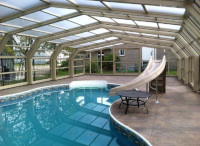 Freeform pool with sliding enclosure