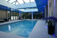 Impressive pool hall roof with LED star type lights and large glazing area