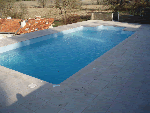 rectangle outdoor pool with steep site and large paving area