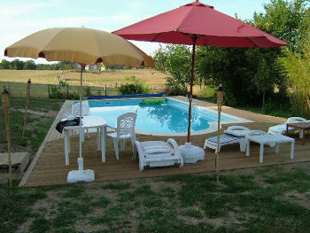 Inground Pool With Wood Deck Surrounding And No Stone Paving
